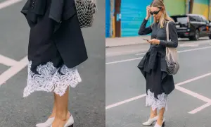 Elegancka koronkowa spódnica stylizacje z czarną marynarką i siatkową torbą. Kobieta w okularach przeciwsłonecznych i szarej bluzce z długim rękawem.