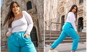 Kobieta plus size, co to znaczy? Pewność siebie w turkusowych dresach przed monumentalną budowlą.