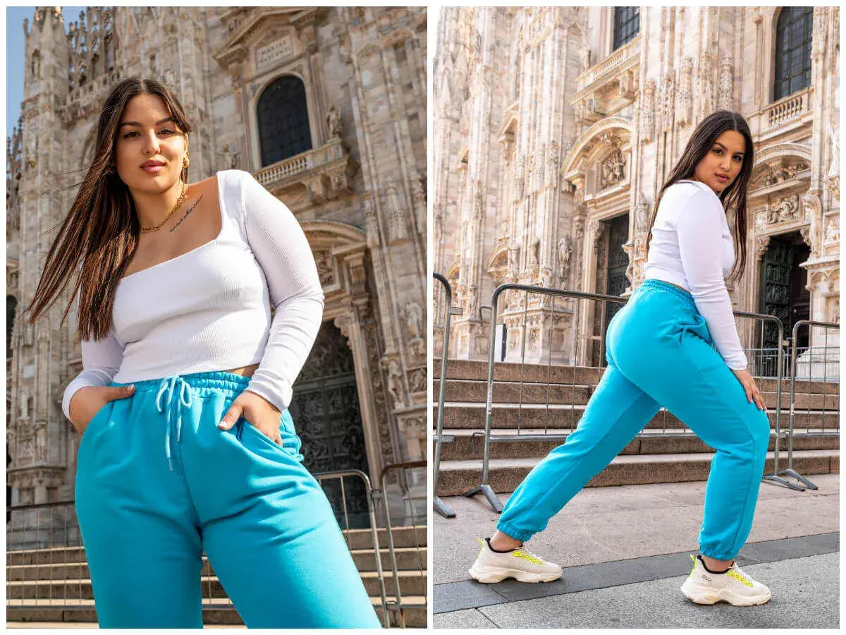 Kobieta plus size, co to znaczy? Pewność siebie w turkusowych dresach przed monumentalną budowlą.